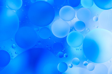 water drops on glass with blue background, close-up 