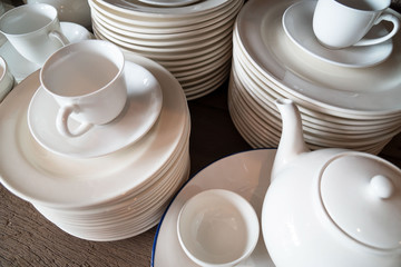 Many white plates are stacked together.a stack of white dish .