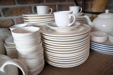 Many white plates are stacked together.a stack of white dish .