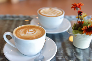 hot caramel macchiato and latte coffee drink put on table in cafe