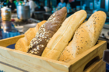 Baked mixed of dark whole wheat and white bread on table