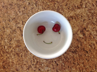 smiling cherries in bowl