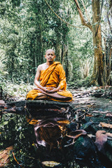 Buddist monk made meditation in deep forest