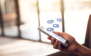 Hand using smart phone with Social media, social network concept, copy space.