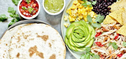 Mexican Buddha bowl with chicken meat fiber, black beans, corn, avocado rose, nachos corn chips. served with avocado sauce (avocado mayonnaise) and tomato salsa (Pico de Gallo) and tortillas
