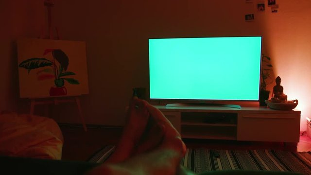 Couple’s Feet Touching Lying On The Bed Watching TV. Loving Woman And Man Relaxing After Work.