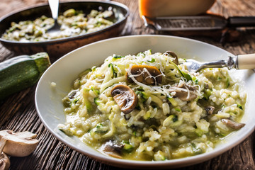 Italian risotto zucchini mushrooms and parmesan in white plate