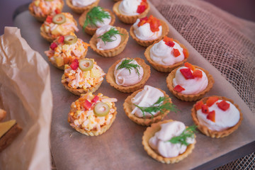 Tasty and juicy snacks for buffet table: mini burgers, canapés, fruit, sliced and baked