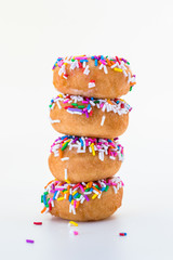tall stack of mini sprinkle doughnuts