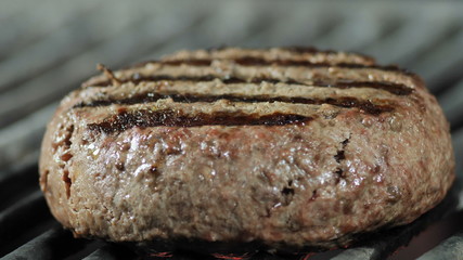Cooking grilled cutlets, close-up of parquet cutlet on roasted grill, ingredients for a burger