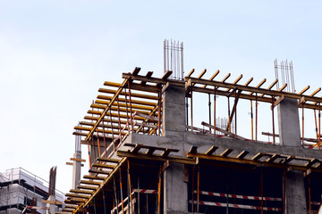 Fragment of the construction of the building against the sky. Cropped shot, horizontal, a lot of free space for text, background. Concept of construction and technology.