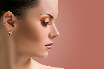 Beauty Girl. Portrait of Beautiful Young Woman half face. Isolated on background indian shade red. Fresh Clean Skin