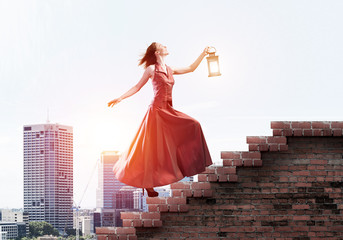 Fototapeta premium Girl in long dress going up the stairway. Mixed media