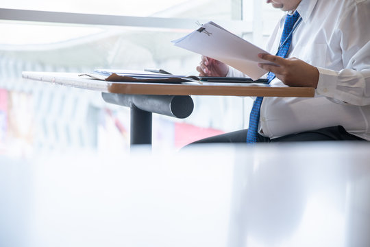 Businessman working on data and documents - Powered by Adobe