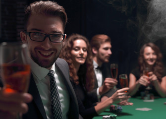 poker players with a glass of wine ,sitting at a table