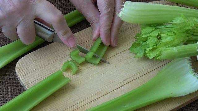 Sliced fresh celery on a cutting wooden board. Healthy food. 