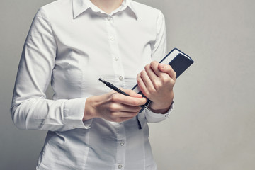 Businesswoman with organizer diary in her hands