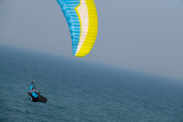 some paragliders fly along the steep coast of the Baltic Sea