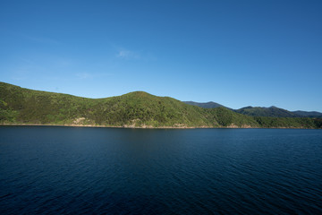 Marlborough Sounds in New Zealand on a clear sunny day - view from the ferry crossing between Wellington and Picton