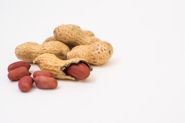 Dried peanuts close-up on a white background. Peanuts without shells. Healthy vegetarian food. The concept of a healthy lifestyle.