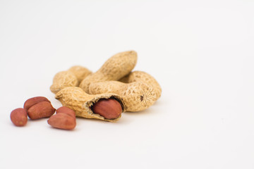 Dried peanuts close-up on a white background. Peanuts without shells. Healthy vegetarian food. The concept of a healthy lifestyle.