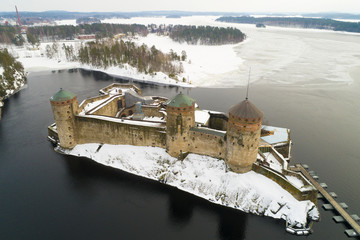 Fototapeta na wymiar View of the ancient fortress of Savonlinna on overcast March day (aerial photography). Finland