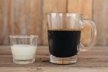 Traditional Vietnamese milk coffee on wooden background