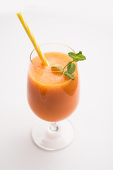 Musk melon juice with slice, also known as Kharbuj/kharbuja fruit extract, served in a glass with mint. selective focus