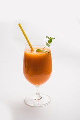 Musk melon juice with slice, also known as Kharbuj/kharbuja fruit extract, served in a glass with mint. selective focus