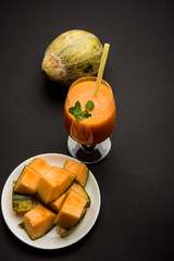 Musk melon juice with slice, also known as Kharbuj/kharbuja fruit extract, served in a glass with mint. selective focus