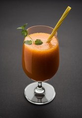 Musk melon juice with slice, also known as Kharbuj/kharbuja fruit extract, served in a glass with mint. selective focus
