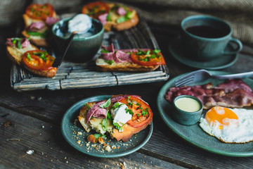 rustic breakfast, baked with basil, tomato, salami and cheese slices of bread, fried egg and bacon