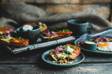 rustic breakfast, baked with basil, tomato, salami and cheese slices of bread, fried egg and bacon