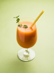 Musk melon juice with slice, also known as Kharbuj/kharbuja fruit extract, served in a glass with mint. selective focus