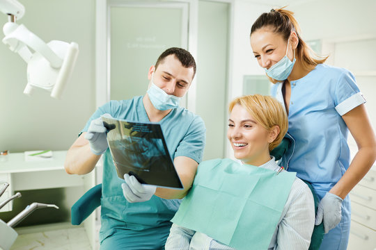 Dentist with a patient look at x-ray image