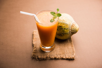 Musk melon juice with slice, also known as Kharbuj/kharbuja fruit extract, served in a glass with mint. selective focus