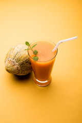 Musk melon juice with slice, also known as Kharbuj/kharbuja fruit extract, served in a glass with mint. selective focus