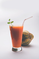 Musk melon juice with slice, also known as Kharbuj/kharbuja fruit extract, served in a glass with mint. selective focus