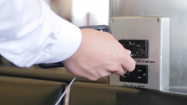 plugging in usb to charger cell phone at airport