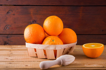 Fresh oranges fruit in the box on wooden boards. Citrus fruit for making juice with a manual...