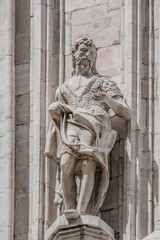 Obraz premium Decorative Religious figure at facade of the Cathedral of Milano, Milan, Italy