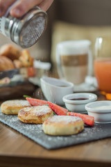 pancakes with cottage cheese for breakfast in a cafe, restaurant. Pancakes with cheese and strawberries, and mint