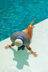Woman relaxing in swimming pool at spa resort. r