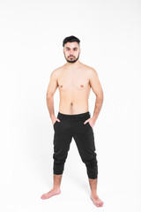 Fototapeta premium Bodybuilder posing. Handsome power athletic guy male. Young muscular man with hands on his pants,isolated on white.