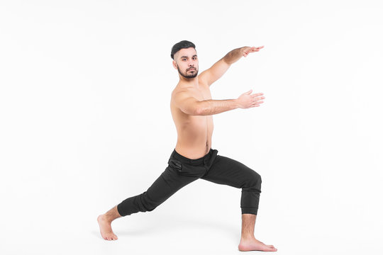 Handsome young ballet dancer on white background.  Muscular sports man wearing at black pants.