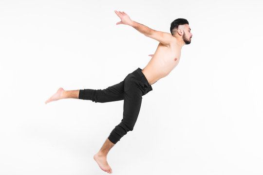 Handsome young ballet dancer on white background , tricks in the air.
