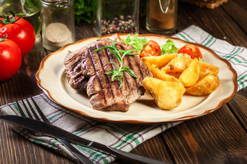 Succulent portions of grilled fillet mignon served with baked potatoes