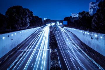 Fototapeta premium Urban Nightscape Architecture Street and Fuzzy Car Lights..