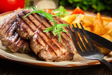 Succulent portions of grilled fillet mignon served with baked potatoes