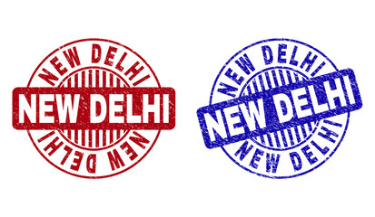Grunge NEW DELHI round stamp seals isolated on a white background. Round seals with grunge texture in red and blue colors. Vector rubber watermark of NEW DELHI caption inside circle form with stripes.